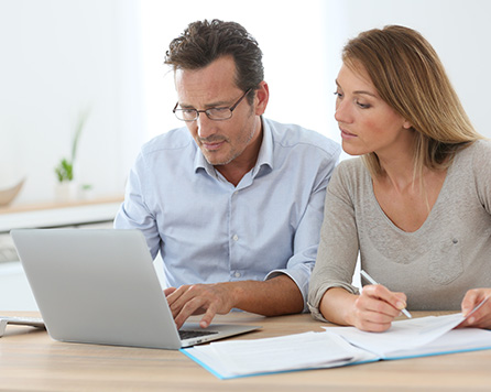 Middle-aged couple researching remortgage advice online