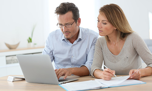 Middle-aged couple researching remortgage advice online